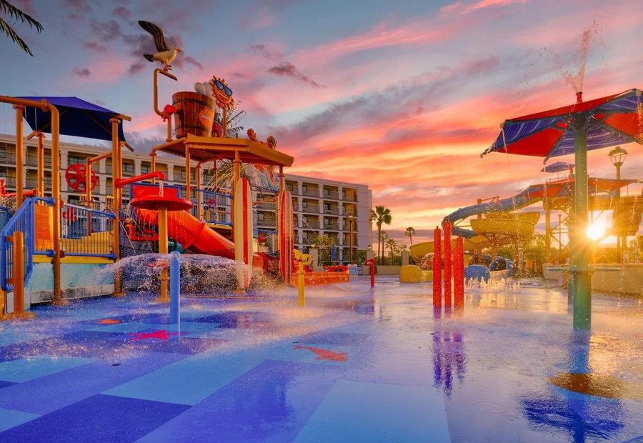 Colorful splash pad and water play park at sunset